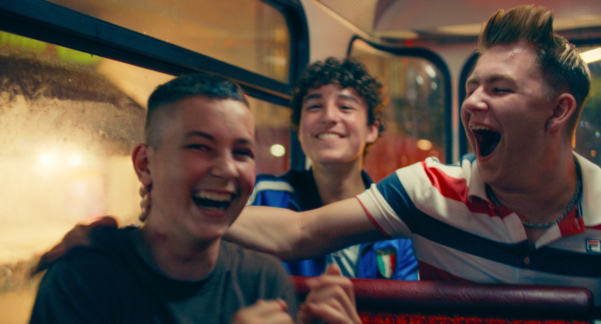 Junges die Spaß haben und lachend in einem Berliner Bus sitzen. Szene aus Sonne und Beton.