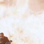Arnold Schwarzenegger als TERMINATOR mit Edward Furlong auf einem Motorrad. Hinter ihnen ein Flammenmeer.